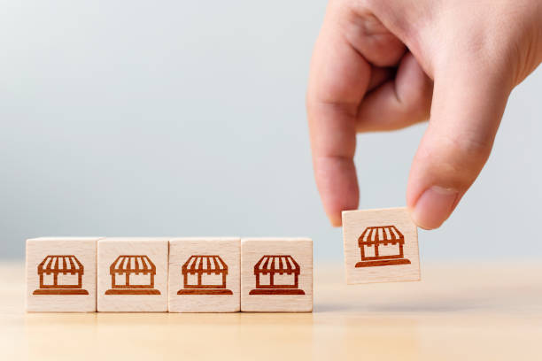 istock Franchise business marketing system concept. Structure service store network strategy. Hand choose wooden block with icon store 1288546652