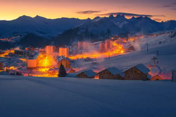 Photo of Majestic ski resort with dawn lights, La Toussuire, France