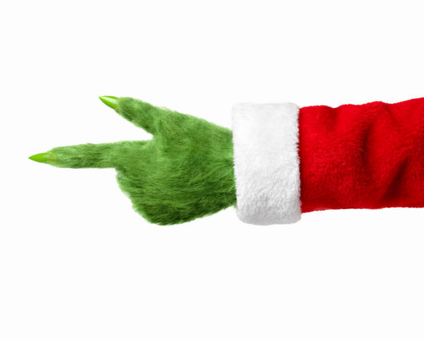 istock A green hairy hand in a Santa suit points to the left 1288548222