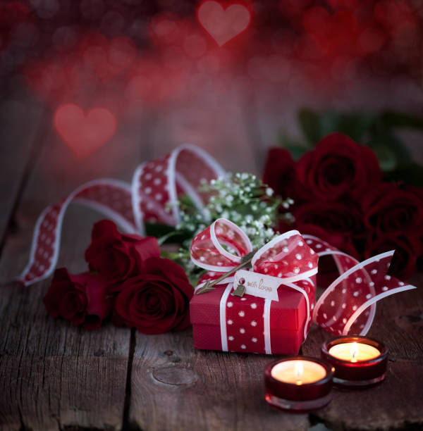 istock Valentine's Day Gift with Red Roses on a Dark Wood Background 1288552938