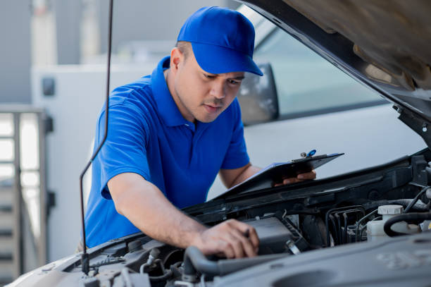 istock A young Asian auto mechanic opens the bonnet. To check for engine damage And perform professional maintenance. He wearing blue uniform. 1288555847