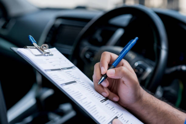 istock A car maintenance worker is checking a list of the car interior for a workshop customer. 1288555991