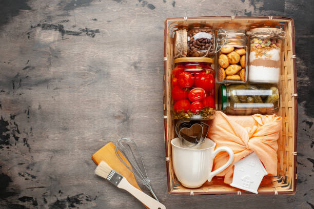 istock Cookies, cucumbers and tomatoes in jars in a gift basket. Top view. Donation. Zero waste 1288557296