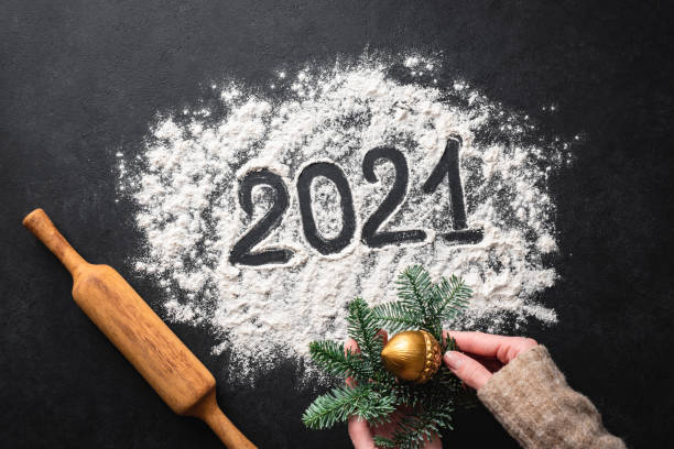 istock 2021 written with flour on black background 1288559519