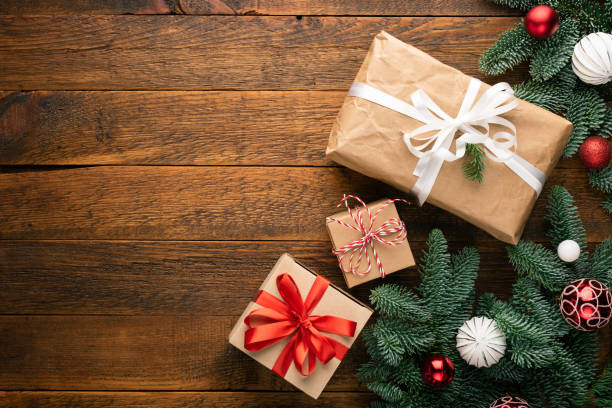 istock Christmas Gift Boxes On Wooden Background 1288559533
