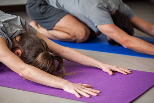 istock Couple exercising in living room 1288561118