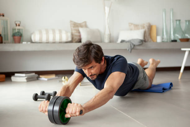 istock Man exercising in living room 1288561181