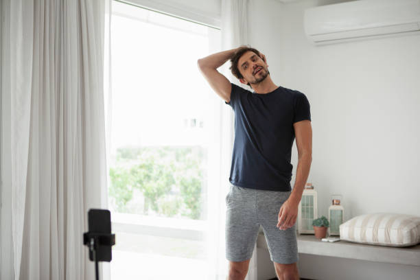 istock Man stretching in living room 1288561196