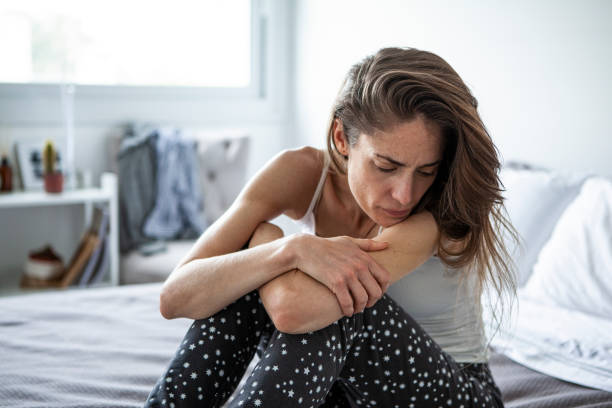 istock Sad woman sitting in bedroom 1288561266
