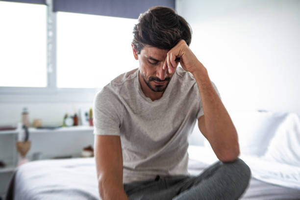 istock Sad man sitting in bedroom 1288561267