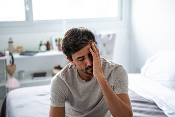 istock Sad man sitting in bedroom 1288561269