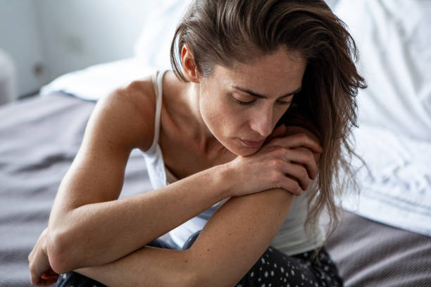 istock Sad woman sitting in bedroom 1288561270