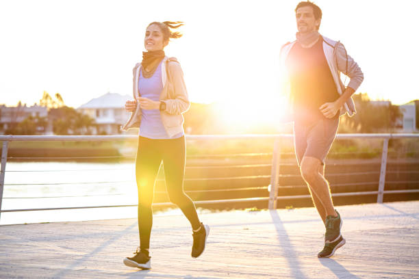 istock Couple jogging on boardwalk 1288561305