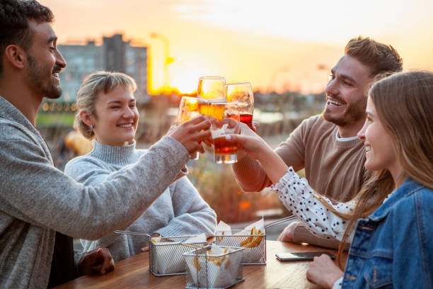 istock Friends toasting beer glasses during sunset 1288561465