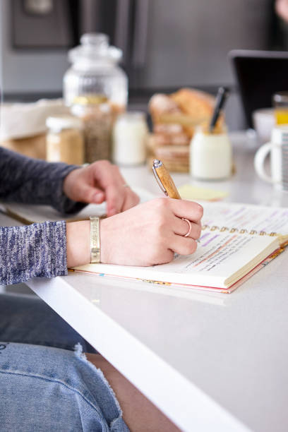 istock Teenage girl writing in diary 1288561699