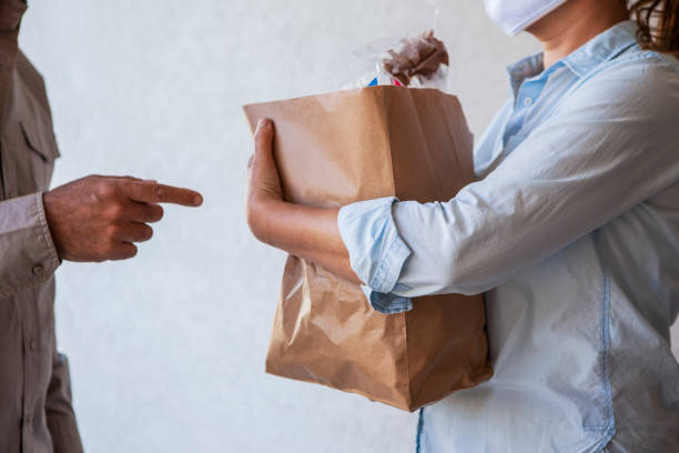 istock Delivery man delivering groceries 1288561784