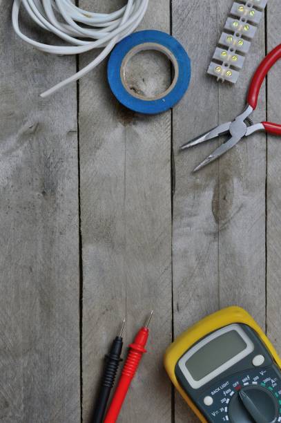 istock electro tool and tester on a wooden background. copy space 1288562798