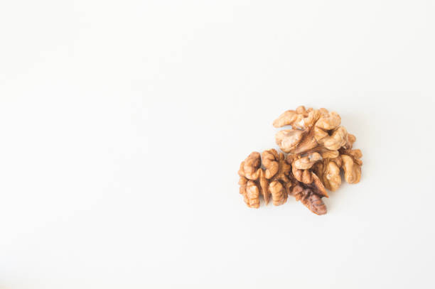 istock Walnuts peeled and shelled on a white background. 1288563182