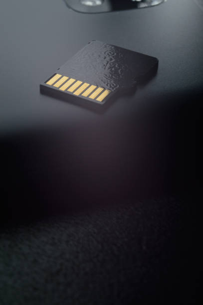 istock Flash memory storage concept: Micro SD card on the background of a smartphone. A memory card is used to store digital information in portable electronic devices such as mobile phones, tablets, etc. 1288564392