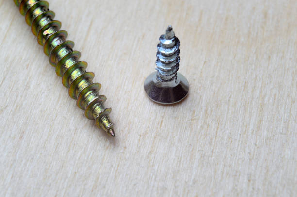 istock self-tapping screw big and small on a wooden background. close-up. 1288565078