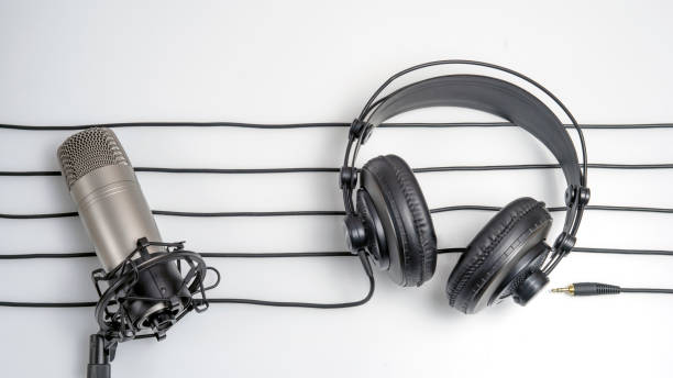 istock music studio background with headphones and microphone 1288565426