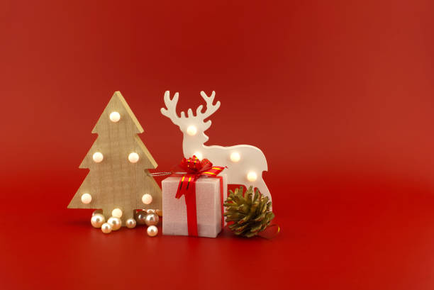 istock Christmas tree and gift box with reindeer and cone 1288565453