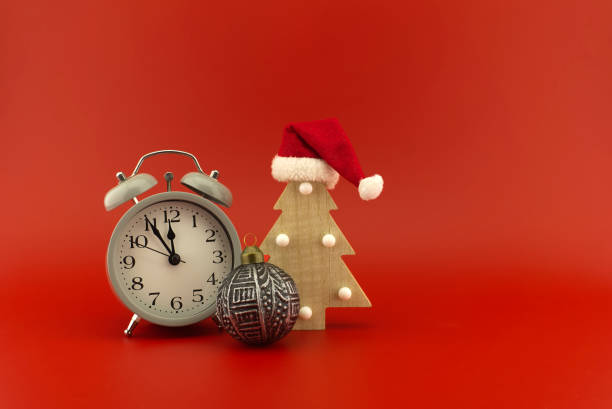 istock Christmas tree with Santa hat and vintage clock 1288565458