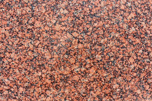 Abstract red granite textured background with copy space for your text and decorations.
