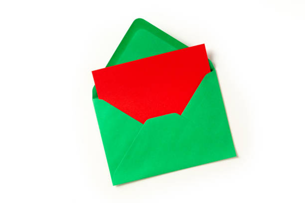 istock Christmas greeting card in a green envelope, shot from above on a white background 1288566496
