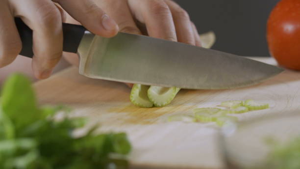 istock hand of an expert chef cuts celery 1288568394