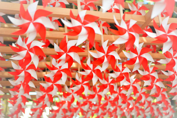 A landscape of Japan where red and white pinwheels are lined up  in Kawagoe Hikawa Shrine.\nMatchmaking pinwheel