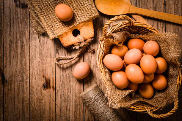 Organic eggs on wooden background, ready for baking.