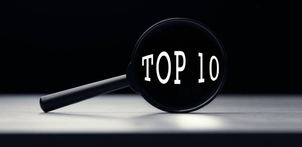 istock Magnifying glass with the text Top 10 on table 1288572197