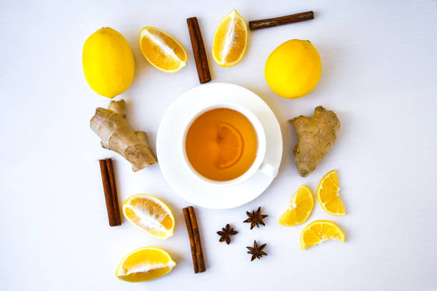 istock Trendy flat lay Ginger hot immunity boosting Vitamin natural drink With citrus lemon cinnamon anise in a rustic style on white background. Chamomile tea 1288572215