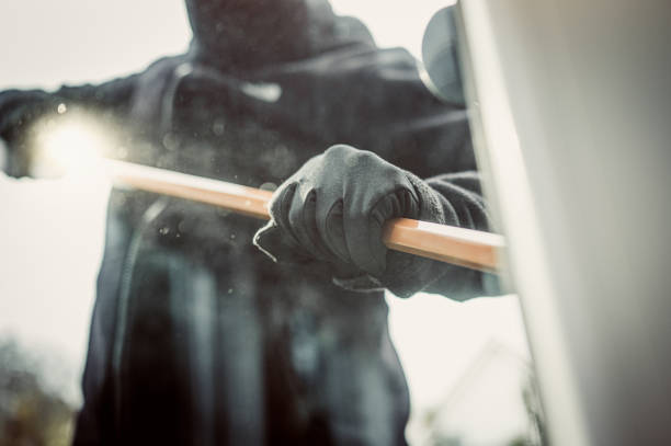 Burglar picking lock Burglary breaking into family home with a crowbar burglary crowbar stock pictures, royalty-free photos & images