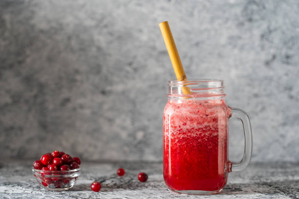 cranberry and cowberry smoothie in mason jar with bamboo straw. refreshing summer fruit drink. the concept of healthy eating. copy space - vitality food food and drink berry fruit imagens e fotografias de stock