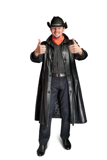 istock Cowboy in a leather coat shows a gesture with his hands. 1288575647