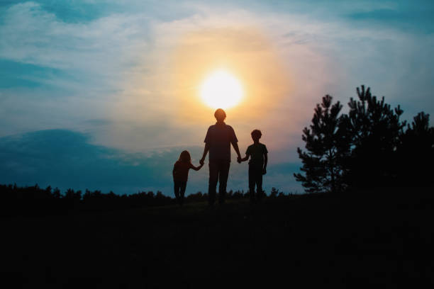 istock father with son and daughter walk at sunset 1288575897
