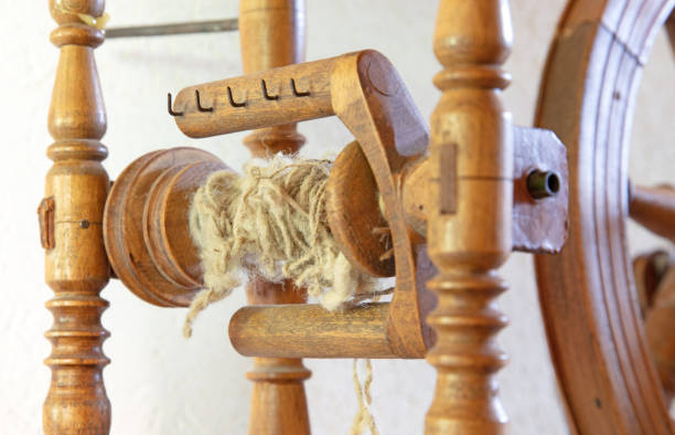 istock Ancient wooden spinning wheel, selective focus on the wool 1288576545
