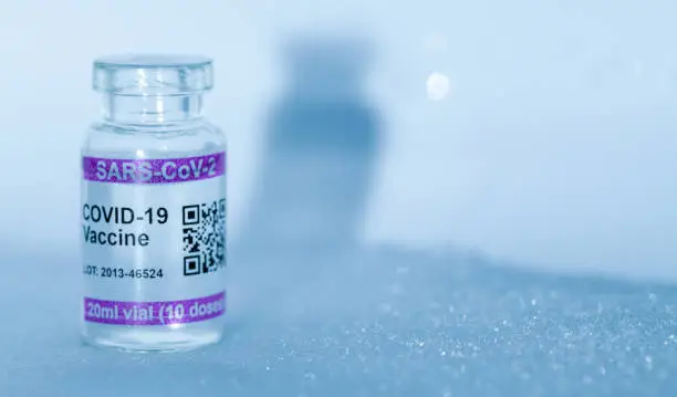 Bottle with COVID-19 (SARS-CoV-2) Coronavirus vaccine vial. Copy space provided.

Note: QR code on bottles was generated by me and contains generic text: "SARS-CoV-2 Vaccine"