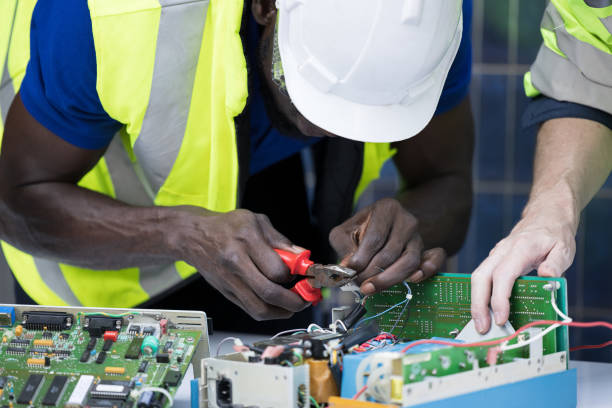 istock Engineer working repairing electric panel with solar panels background, Concept teamwork or training of renewable. 1288578986