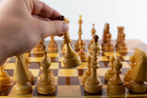 istock a man takes a step with a chess piece 1288579695