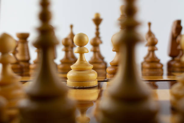 istock chessboard made of wooden pieces on white 1288580258