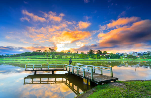istock Dawn by the large lake with impressive clouds reflecting 1288580302