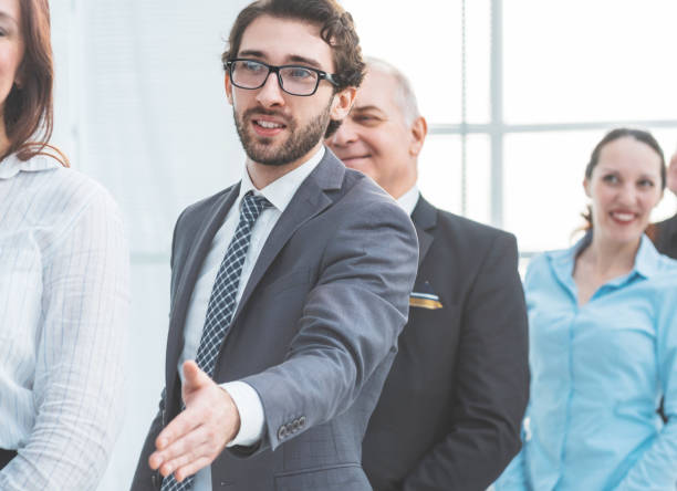 istock close up. young entrepreneur holding out his hand for a handshake 1288582070
