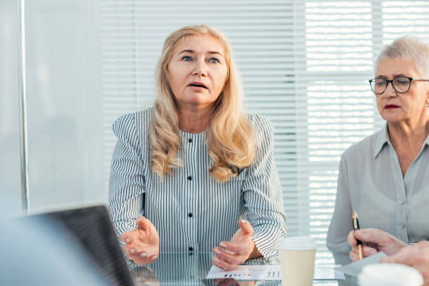 istock serious business woman explaining something to her colleagues 1288582080