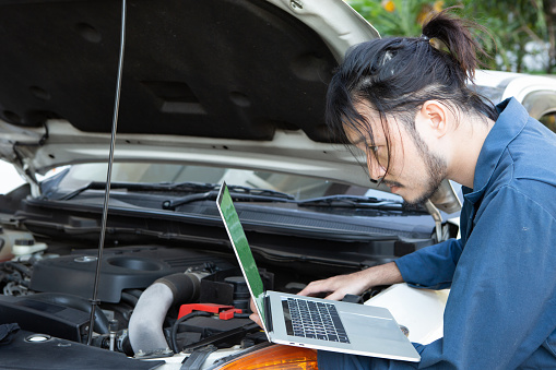 Auto Mechanic Testing Asian Auto Mechanic Testing Car Ecu With Laptop Stock Photo - Download ...