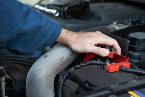istock Closeup hand of auto mechanic checking car battery 1288583440