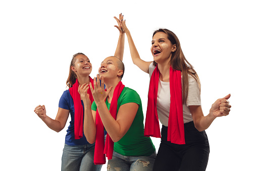 Togetherness. Female soccer fans cheering for favourite team with bright emotions isolated on white studio background. Beautiful caucasian women look excited, supporting. Concept of sport, fun, support.