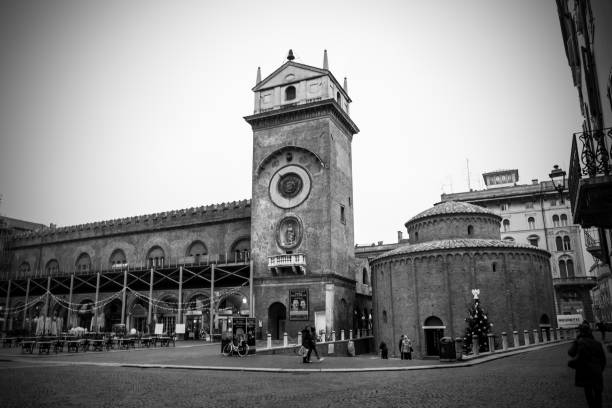 The Clock Tower and The church of the Rotonda San Lorenzo, Piazza delle Erbe, Mantua, Italy Mantua, Lombardy, Italy, December 2015: The Clock Tower and The church of the Rotonda San Lorenzo located in Piazza delle Erbe, during the Christmas Time. Black and White photography. san lorenzo rome photos stock pictures, royalty-free photos & images